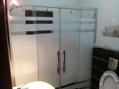 a bathroom with a shower stall and a toilet at Apartment in Abdoun Al Janobi in Amman