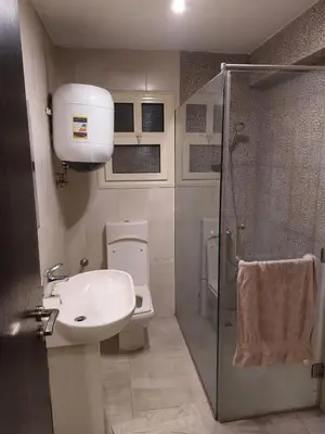 a bathroom with a toilet and a sink and a shower at Full sky apartment in Irbid