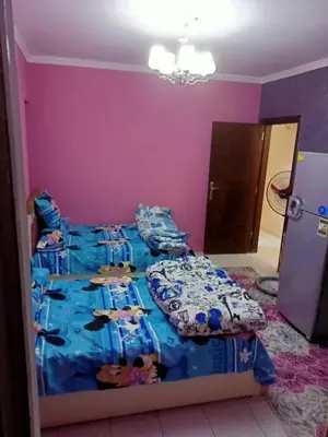 a bedroom with a large bed in a purple room at Full sky apartment in Irbid