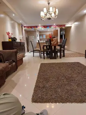 a living room with a couch and a table and chairs at Full sky apartment in Irbid