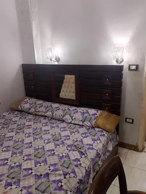 a bedroom with a bed with a purple comforter at المناخير هوستل in Amman