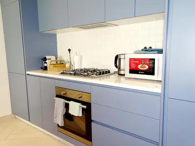 a kitchen with a stove and a microwave at B12 beach apartment Ayla in Al Jafr