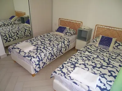 a room with three beds and a mirror at B12 beach apartment Ayla in Al Jafr