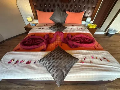 a bedroom with a large bed with colorful blankets and pillows at Luxury diamond camp in Wadi Rum