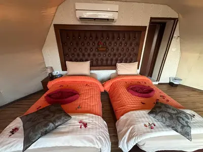 two beds sitting next to each other in a room at Luxury diamond camp in Wadi Rum