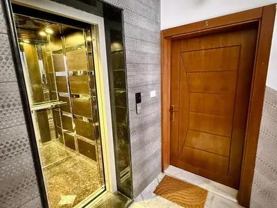 a bathroom with a shower and a wooden door at Beit Ahlan Suites 8 in Amman