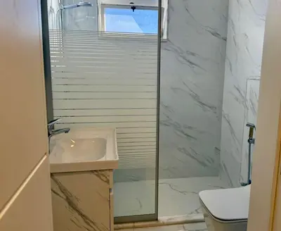a bathroom with a sink and a shower at Beit Ahlan Suites 8 in Amman