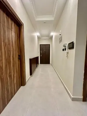 an empty corridor with a door and a corridorngthngthngthngthngthngthngth at Modern Residence for families only in Amman