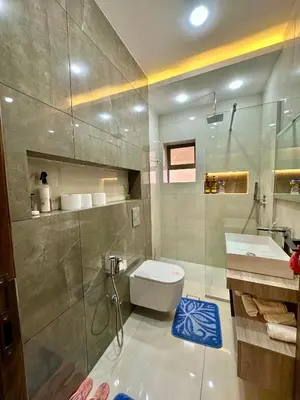 a bathroom with a toilet and a sink and a shower at Modern Residence for families only in Amman