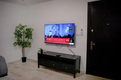 a living room with a flat screen tv on a wall at Apartment in Amman 7th Circle near Cozmo market in Amman