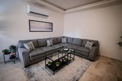 a living room with a couch and a table at Apartment in Amman 7th Circle near Cozmo market in Amman
