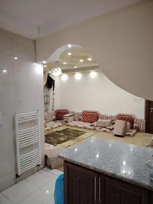 a living room with couches and a table in a room at mraco apartment in Amman