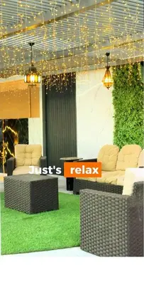 a lobby with two couches and a table with grass at Ras Al Khaimah Farm & Resort