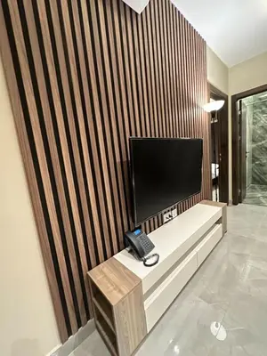 a phone sitting on a bench in a room at Charming Amman Apartment with Modern furnis in Amman