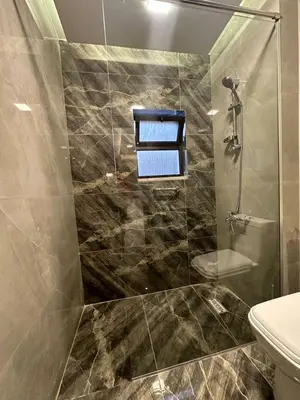 a bathroom with a shower and a toilet at Charming Amman Apartment with Modern furnis in Amman