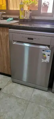 a dishwasher under a counter in a kitchen at A large, fully furnished Apartment in Amman