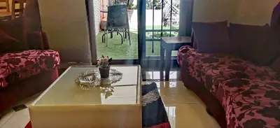 a living room with a couch and a coffee table at A large, fully furnished Apartment in Amman