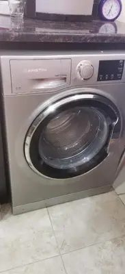 a washing machine with its door open in a kitchen at A large, fully furnished Apartment in Amman