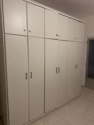 a room with white cabinets in a room at الاردن عمان الجاردنز in Amman