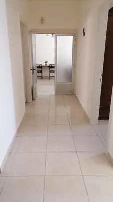 an empty hallway with a large white tile floor at الاردن عمان الجاردنز in Amman