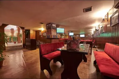 a living room with red chairs and a table at Madaba nebo home in Amman