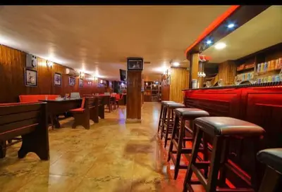 a restaurant with a row of tables and chairs at Madaba nebo home in Amman