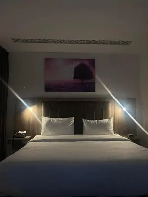 a bedroom with a large bed with lights on it at Madaba nebo home in Amman