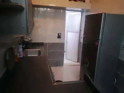a small kitchen with a sink and a refrigerator at العنبق هاوس