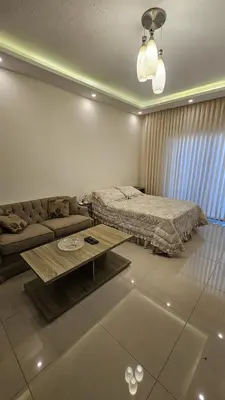 a living room with a bed and a coffee table at Private Studio in Amman