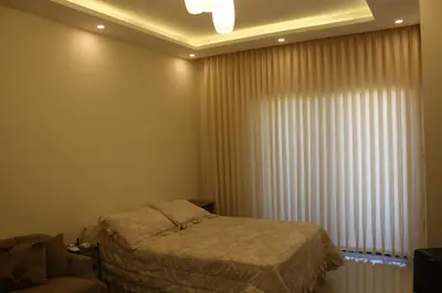 a bedroom with a bed and a window with curtains at Private Studio in Amman