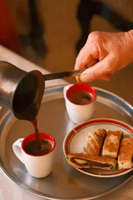 a person is pouring sauce into a plate of food at Room in central Amman in Amman