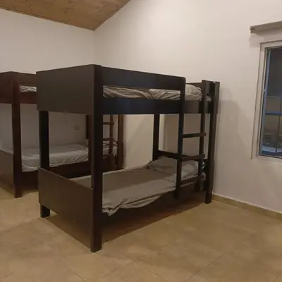 two bunk beds in a room with a window at Chalet Adam- Ajloun شاليه ادم in Ajloun