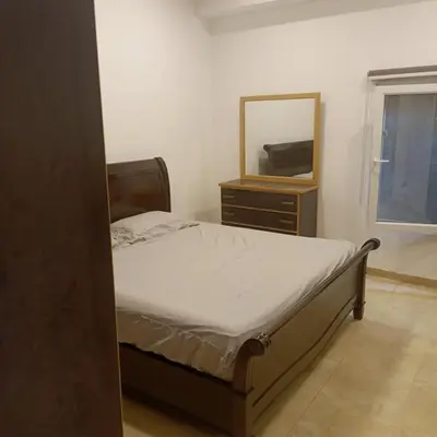 a bedroom with a bed with a mirror and a dresser at Chalet Adam- Ajloun شاليه ادم in Ajloun