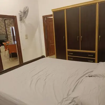 a bedroom with a bed and a wooden cabinet at Chalet Adam- Ajloun شاليه ادم in Ajloun