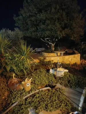 a garden with a statue of a deer and a fountain at Chalet Adam- Ajloun شاليه ادم in Ajloun