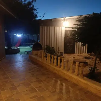 a fence in front of a house at night at Chalet Adam- Ajloun شاليه ادم in Ajloun