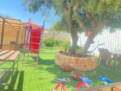 a playground with a tree and a swing set at Chalet Adam- Ajloun شاليه ادم in Ajloun