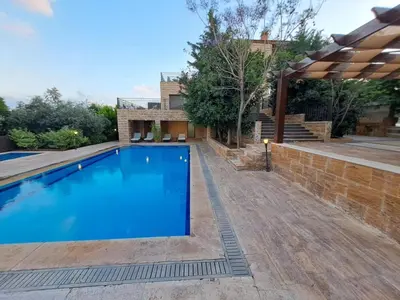 a swimming pool in the backyard of a house at Villa Saya in Jerash