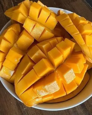 a plate of cut up mangoes on a table at kazami House in At-Tafilah