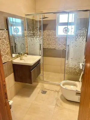 a bathroom with a shower and a sink and a toilet at kazami House in At-Tafilah