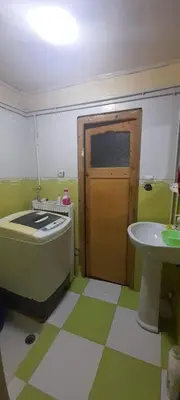 a bathroom with a tub next to a sink at Zomik house in Al Qiḩāţī