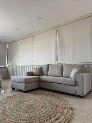 a living room with a couch and a rug at sky view rooftop in Amman