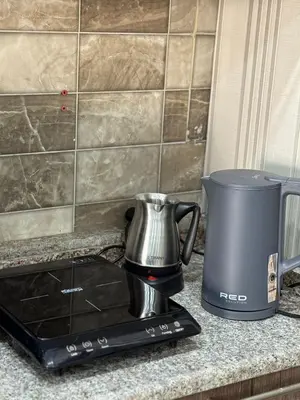 a coffee maker on a counter next to a blender at sky view rooftop in Amman