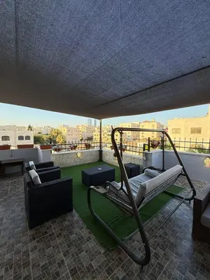 a balcony with a hammock on top of a building at sky view rooftop in Amman