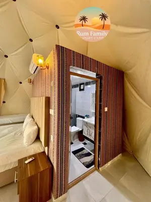 a room with a tent with a bed and a mirror at RUM fAMILY lUXURY CAMP in Wadi Rum