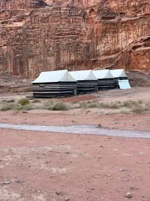 a row of buildings in the desert near a mountain at saleem with jeep tour in Wadi Rum