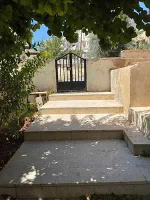 a set of stairs with a gate in a building at Monani in Amman