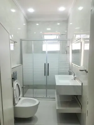 a bathroom with a shower and a toilet and a sink at Monani in Amman