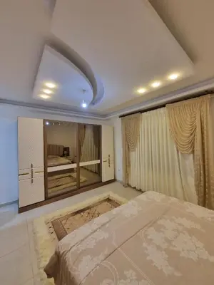 a bedroom with a large bed and a large window at شقة مفروشه فاخرة للايجار الاردن عمان in Amman