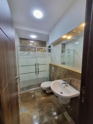 a bathroom with a toilet and a sink and a shower at شقة مفروشه فاخرة للايجار الاردن عمان in Amman